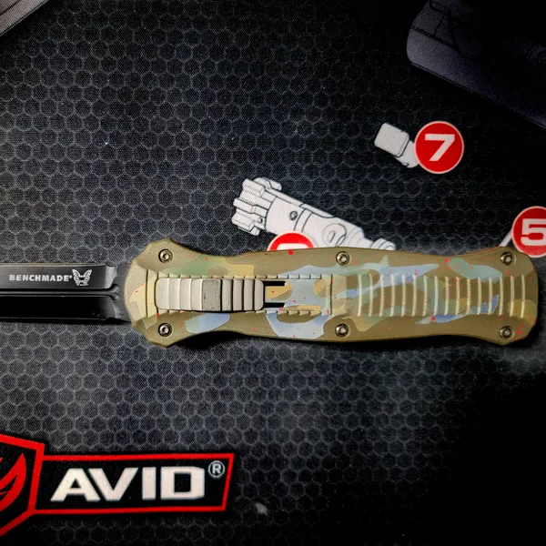 Benchmade out-the-front knife with a multicam-pattern Cerakote handle.