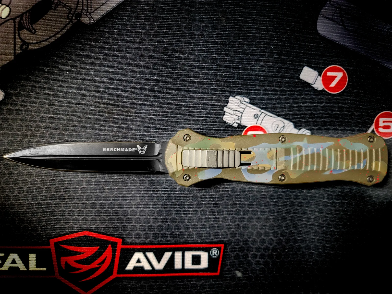 Benchmade out-the-front knife with a multicam-pattern Cerakote handle.