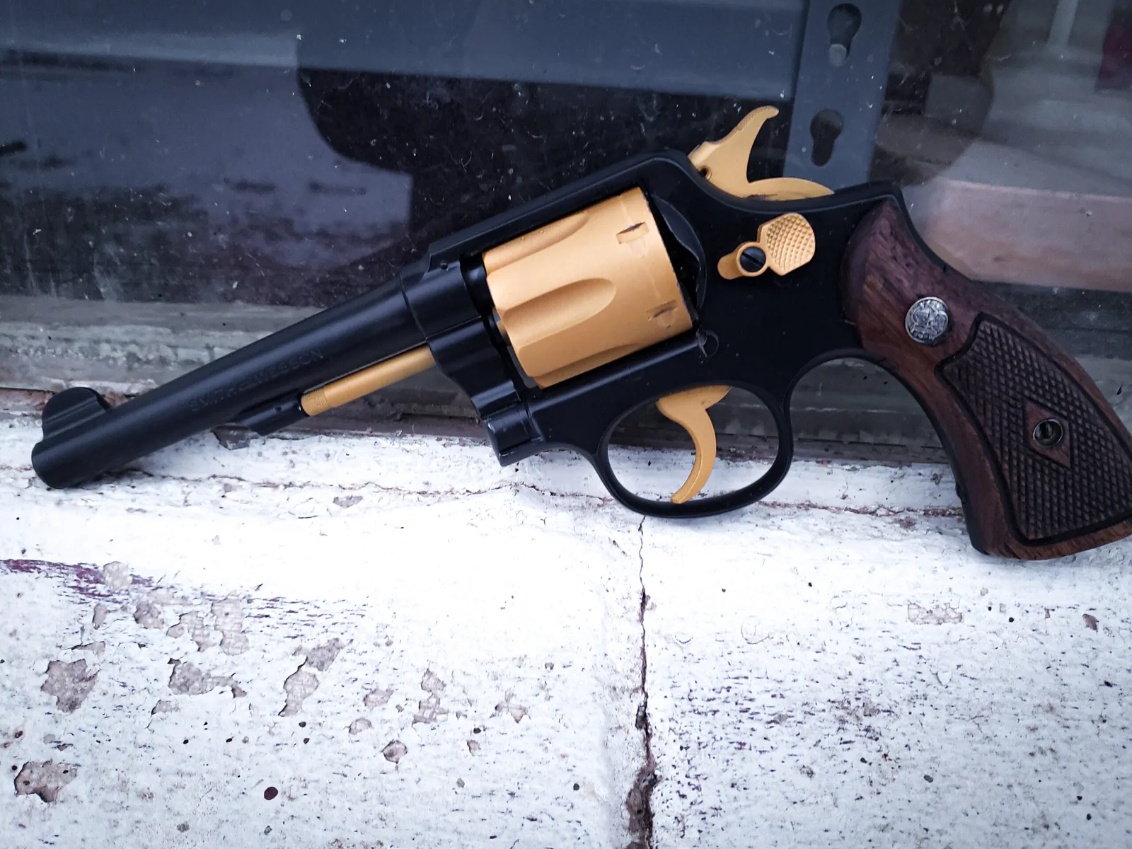 Revolver with a black frame and gold-toned cylinder and controls in a two-tone Cerakote finish.